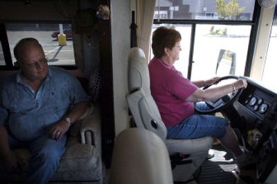 
Spokane resident Bud Flaa peeks over his wife Babe's shoulder as she maneuvers their 35-foot motor home around a parking lot during a driving lesson Thursday at the Life on Wheels conference in Moscow, Idaho. 
 (Holly Pickett / The Spokesman-Review)