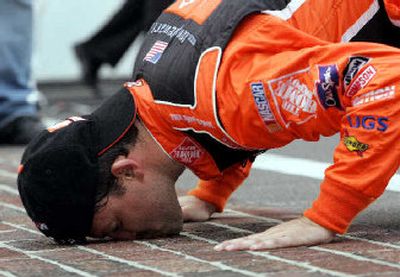 
Tony Stewart kisses the yard of bricks on the start/finish line after winning the Allstate 400 at Indianapolis Motor Speedway.
 (Associated Press / The Spokesman-Review)