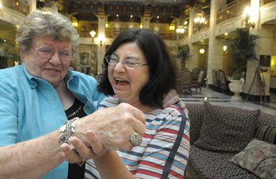 Ruthe Harshman, left, and Mary Christensen laugh about her long-lost charm bracelet after meeting in the lobby of the Davenport Hotel.  (CHRISTOPHER ANDERSON / The Spokesman-Review)