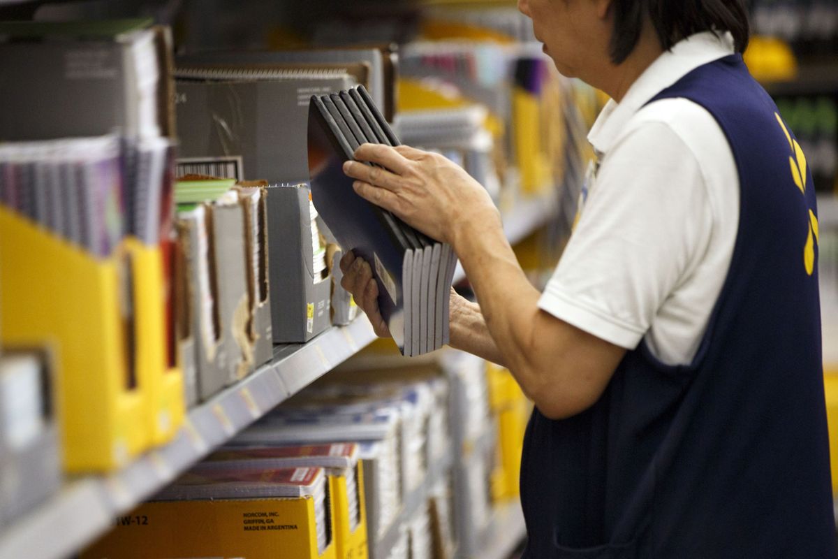 An employee restocks shelves of school supplies at a Wal-Mart Store in Burbank, California, on Tuesday, Aug. 8, 2017.   (Patrick T. Fallon/Bloomberg)