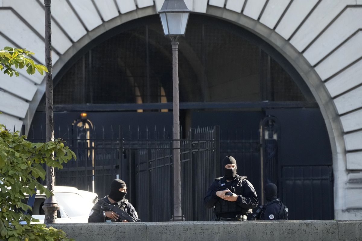 Security forces guard an entrance of the Palace of Justice Wednesday, Sept. 8, 2021 in Paris. France is putting on trial 20 men accused in the Islamic State group