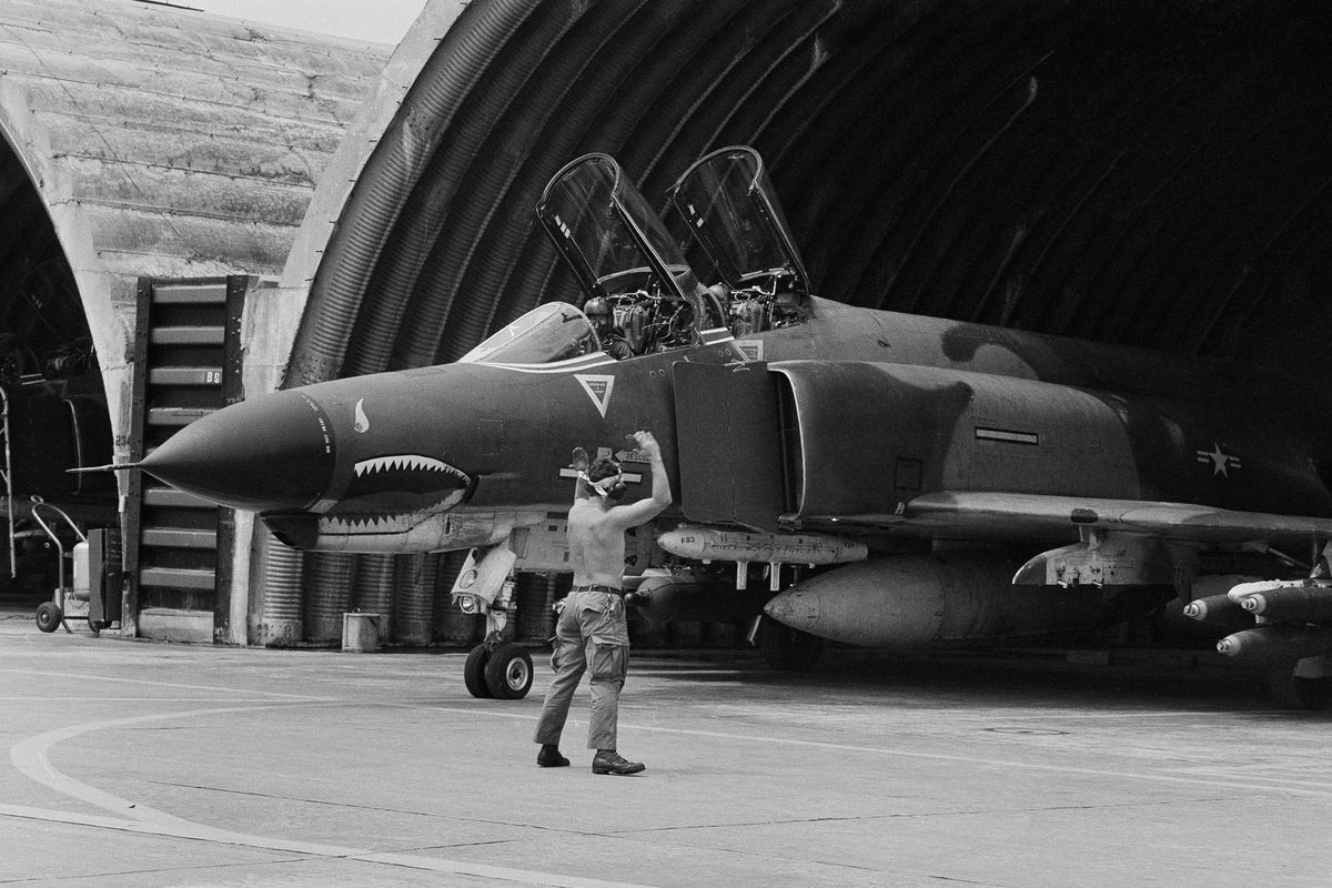 In this April 23, 1966, file photo, a U.S. Air Force F-4 Phantom jet is guided out of its revetment in Da Nang formerly South Vietnam, at the start of a bombing mission over the DMZ area and North Vietnam. (Anonymous / Associated Press)