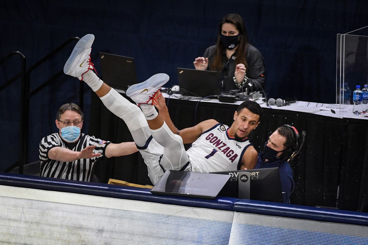 Gonzaga guard Jalen Suggs lands on the scorer’s table after saving a ball from going out of bounds on Jan. 2 against San Francisco at the McCarthey Athletic Center. The Bulldogs won 85-62.  (By Colin Mulvany / The Spokesman-Review)