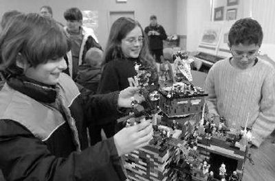 
Vanya Hummel, left, 10, works on his elaborate entry into the recent LEGO-rama. Contestants Dirk Seymour, center, and Ian Van Ostrand, right, look on. 
 (Jesse Tinsley / The Spokesman-Review)