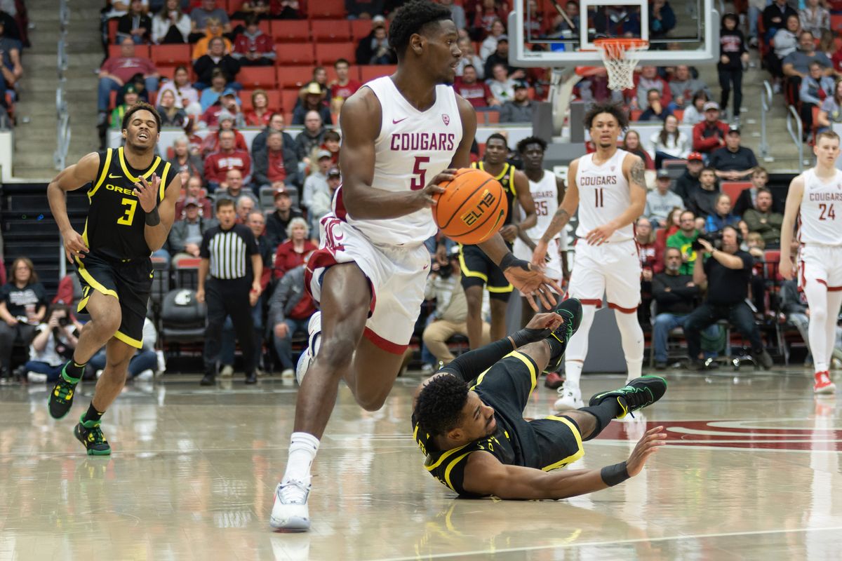 Washington State guard TJ Bamba (5) breaks away from Oregon forward Quincy Guerrier in the first half of a Pac-12 game Feb. 19 at Beasley Coliseum in Pullman. Bamba declared for the NBA draft and entered the NCAA transfer portal on Monday.  (Geoff Crimmins/For the Spokesman-Review)