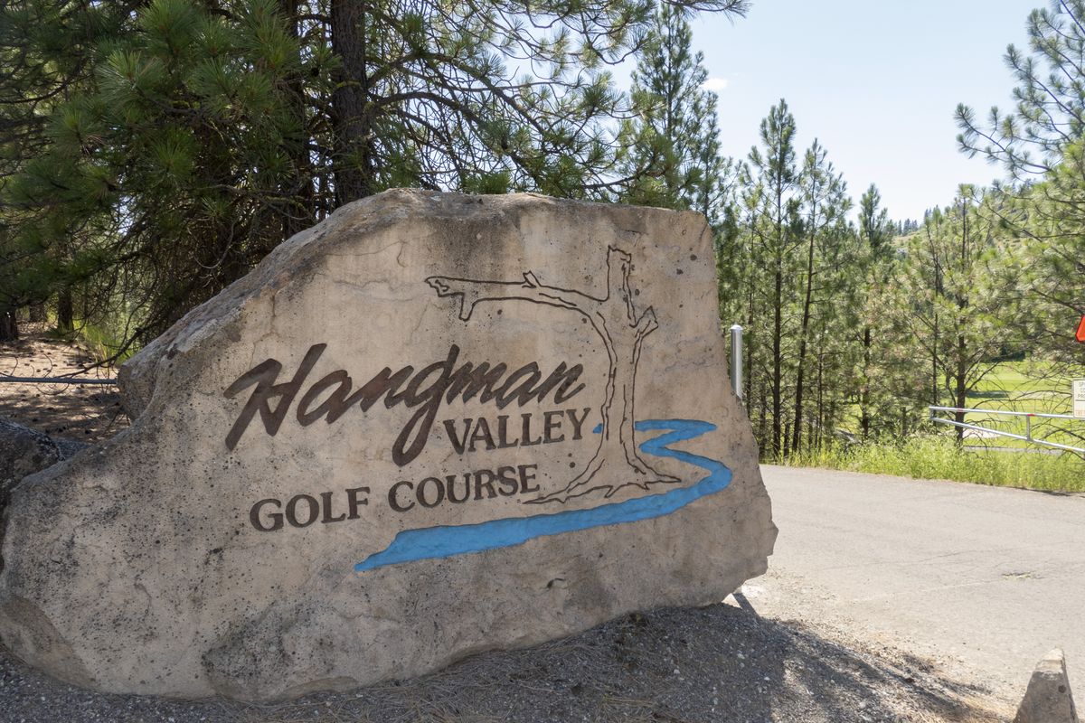This is the sign at the entrance to the Hangman Valley Golf Course, owned by Spokane County, shown Monday, July 13, 2020. The name Hangman Valley, along with Hangman Creek, harkens back to when the U.S. Army executed local Indian leaders by hanging in 1858. Although most maps call the creek and valley by the name Latah, the macabre nickname has stuck.  (JESSE TINSLEY)