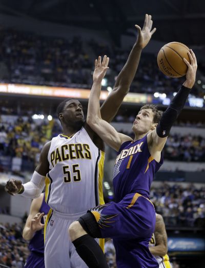 Suns guard Goran Dragic, right, makes a move to the basket against Pacers center Roy Hibbert. (Associated Press)