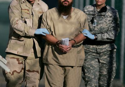 A detainee  is escorted by U.S. military personnel to an annual review board hearing  on Guantanamo Bay in 2006.  (Associated Press / The Spokesman-Review)