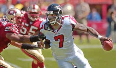 
Versatile quarterback Michael Vick ran for 902 yards for the Atlanta Falcons and led the NFL with 7.5 yards per carry. 
 (Associated Press / The Spokesman-Review)