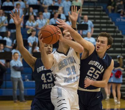 After a rebound, Central Valley's Beau Byus (32) looks for a passing lane as Gonzaga Prep's Jamil Foster (43) and Reed Hopkins (25) defend during a GSL high school boy's basketball game, Tuesday, Jan. 21, 2014, at Central Valley High School. (Colin Mulvany / The Spokesman-Review)