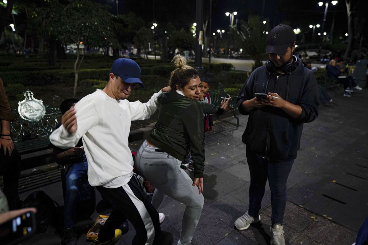 Youths dance during a rap performance at a plaza in the Coyoacan neighborhood of Mexico City, Friday, July 23, 2021. Hours after Mexico City authorities raised the alert level in the face of rising COVID-19 infections, many residents of the capital