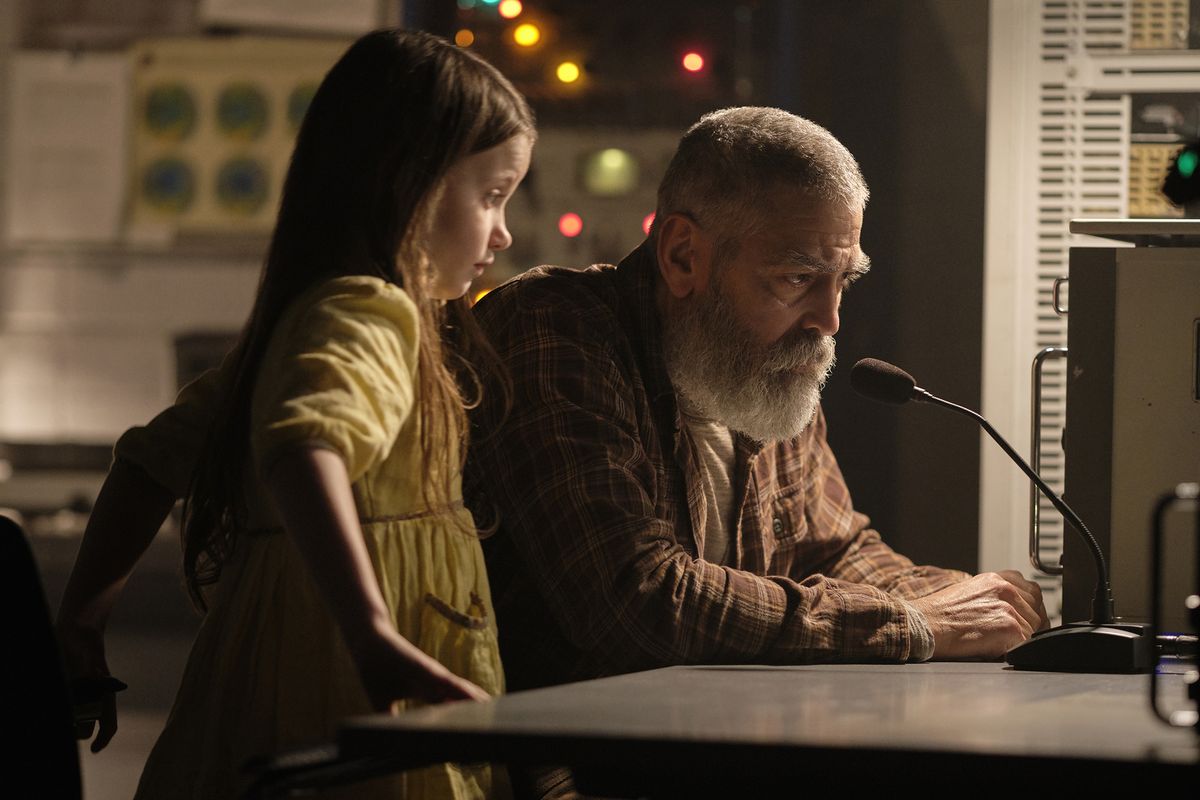 Caoilinn Springall and George Clooney in “The Midnight Sky.” Clooney both stars in and directs the film.  (Philippe Antonello/Netflix)