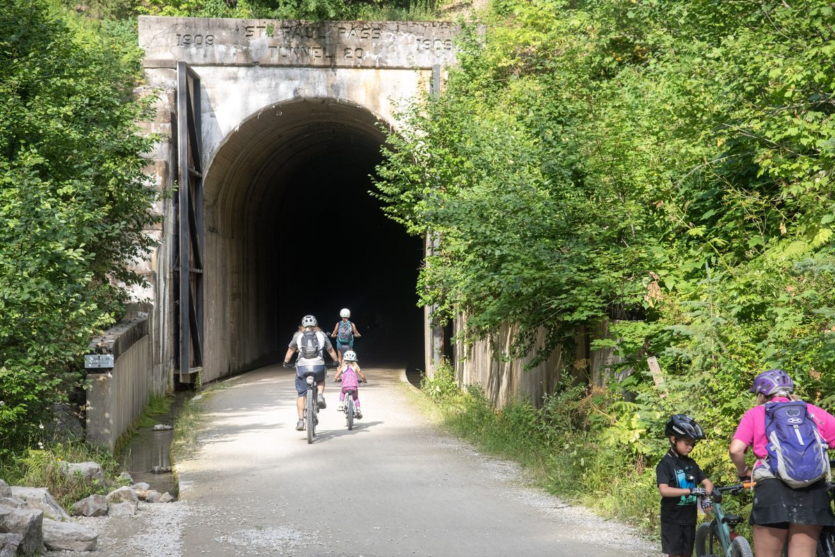 Riders enter the Taft Tunnel on the Route of the Hiawatha trail Aug. 23.  (Michael Wright/The Spokesman-Review)