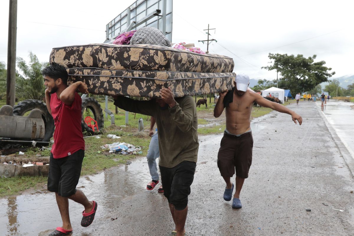 Neighbors help each other as they evacuate the area before Hurricane Iota makes landfall in San Manuel Cortes, Honduras, Monday, November 16, 2020. Hurricane Iota rapidly strengthened into a Category 5 storm that is likely to bring catastrophic damage to the same part of Central America already battered by a powerful Hurricane Eta less than two weeks ago. (Delmer Martinez)