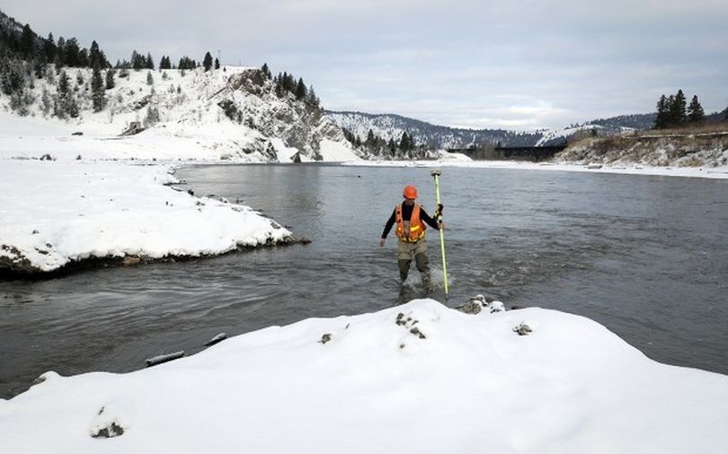 A worker monitors the unleashing of Montana's Clark Fork River into its restored channel near the old site of Milltown Dam. (The Missoulian)