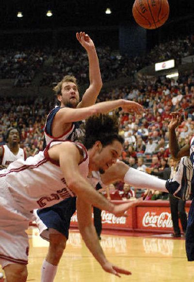 
Gonzaga's Sean Mallon, background, fouls WSU's Derrick Low. 
 (Dan Pelle / The Spokesman-Review)