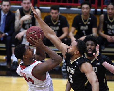 Eastern Washington forward Kim Aiken Jr.  tries to shoot past Idaho forward Quinton Forrest  during the first half Thursday, Feb. 13, 2020, in Cheney. (Colin Mulvany / The Spokesman-Review)