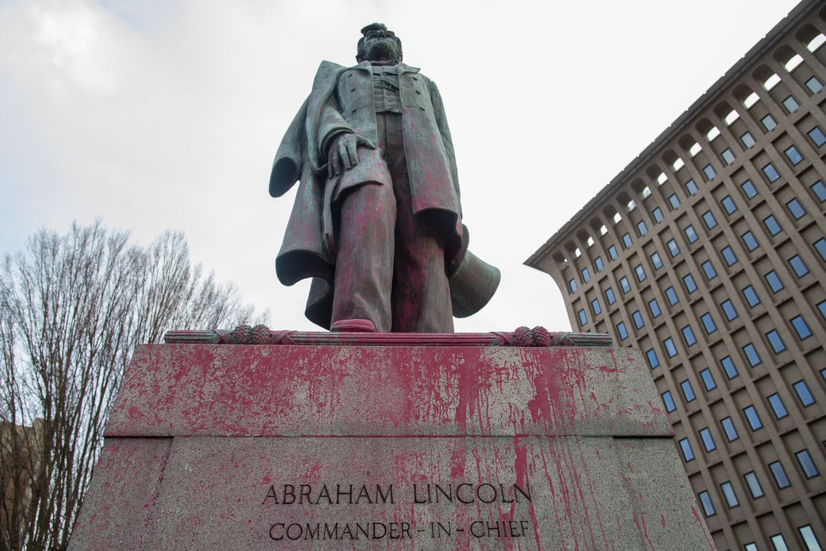 Red paint was splashed onto the statue of Abraham Lincoln at Monroe Street and Main Avenue. The vandalism was discovered Thursday morning.  (Jesse Tinsley/The Spokesman-Review)