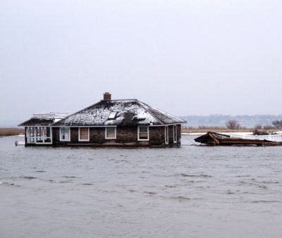 A home sits in Barnegat Bay on Feb. 5. It was washed into the bay from Mantoloking, N.J., during Superstorm Sandy. (Associated Press)