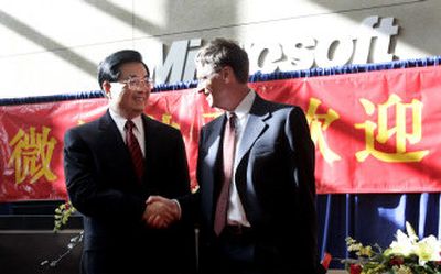 
China's President Hu Jintao, left, shakes hands with Microsoft Chairman Bill Gates at the company headquarters in Redmond, Wash., Tuesday. Hu plans to give a major policy address today.
 (Associated Press / The Spokesman-Review)