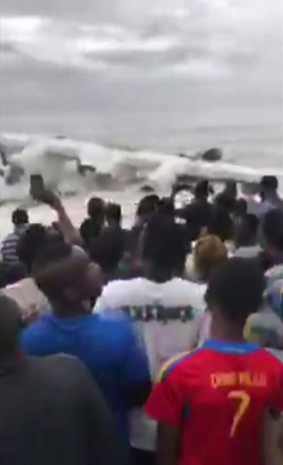 A crowd gathers at the shoreline after a cargo plane crashed Saturday into the Atlantic Ocean shortly after taking off from Ivory Coast's international airport in Abidjan, Ivory Coast, Saturday Oct. 14, 2017. (Ange Koutaye Ismael / Associated Press)
