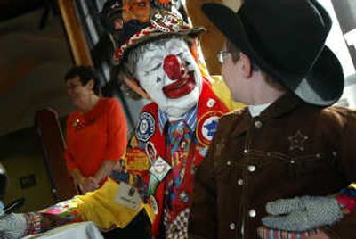 
Johnny Pownall, 5, of North Bend, Wash., talks to clown J.P. Patches at the Seattle Aquarium on Sunday.  J.P. Patches was signing autographs and greeting the public for more than two hours as kids were trick-or-treating at businesses on the waterfront. Associated Press
 (Associated Press / The Spokesman-Review)