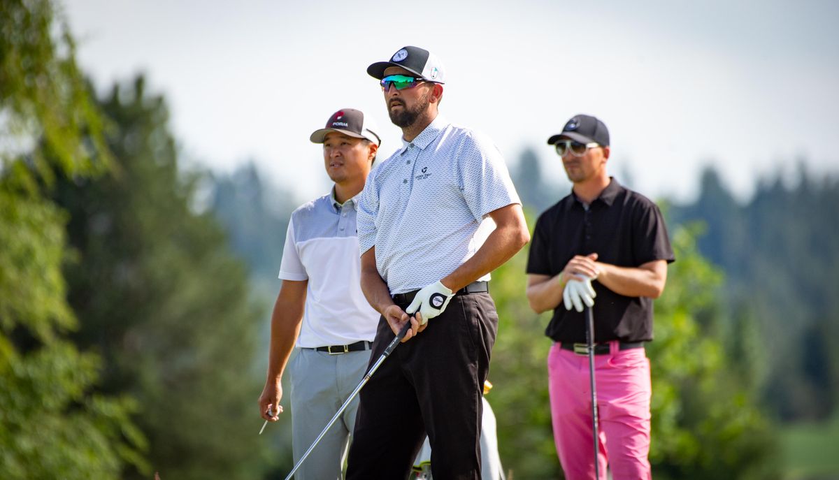 Peter Lansburgh (center) watches to see where his drive ends up alongside opponents T.K. Kim (left) and Jesse Schutte during the Lilac Invitational on Sunday, June 9, 2019 at The Fairways Golf Course. (Libby Kamrowski / The Spokesman-Review)
