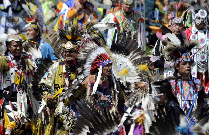 The grand entry of dancers is a colorful affair every year at the Julyamsh powwow at the Coeur d’Alene Greyhound Park.