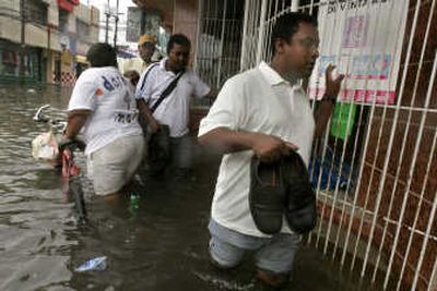 
People wade through a flooded street in La Ceiba, Honduras, on Tuesday after Hurricane Felix made landfall. At least three deaths were blamed on the powerful storm. Associated Press
 (Associated Press / The Spokesman-Review)