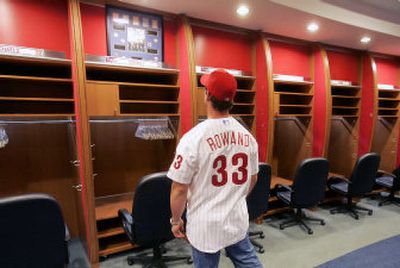 Former Chicago White Sox center fielder Aaron Rowand wears his new  Philadelphia Phillies cap and shirt as he does interviews following a news  conference in Philadelphia on Friday, Nov. 25, 2005. To