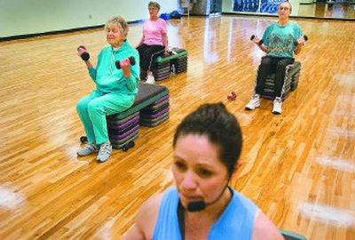 
From back left, Carol Bamer, Doramae Dionne and Wes Todd work out during Group Fitness 101 led by Becky Jones, front, at Oz Fitness in Spokane Valley.
 (Christopher Anderson / The Spokesman-Review)