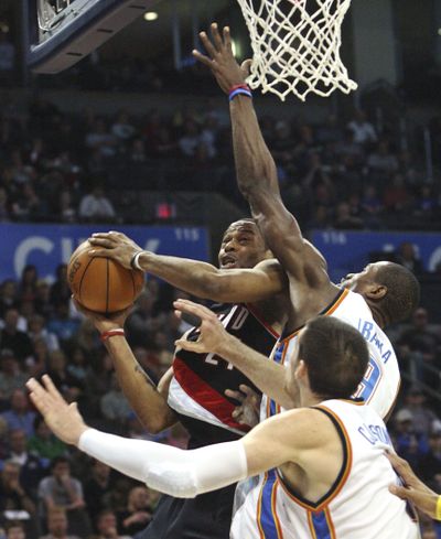 Trail Blazers center Marcus Camby shoots around Thunder forwards Nick Collison, front, and Serge Ibaka in 92-87 win. (Associated Press)