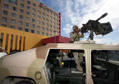 
A soldier stands guard Thursday in front of the Camino Real Hotel in Ciudad Juarez, Mexico, where Mexican government officials announced an anti-organized crime initiative for the border city. Associated Press
 (Associated Press / The Spokesman-Review)