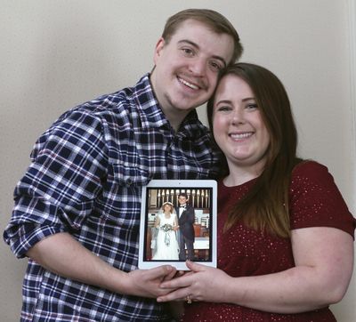 Scott Iwan and his fiance Ame Bartlebaugh hold a 1980 photo Ame's mother in her wedding dress the day she was married. (PHIL MASTURZO / Associated Press)