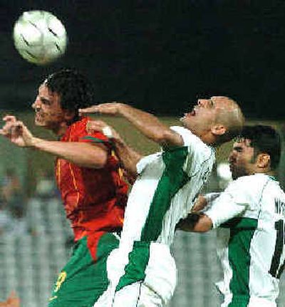 
Portugal's Hugo Almeida, left, fights for a high ball with Iraq's Abbas Bassim, center, and Haidar Abdul Razzaq. 
 (Associated Press / The Spokesman-Review)