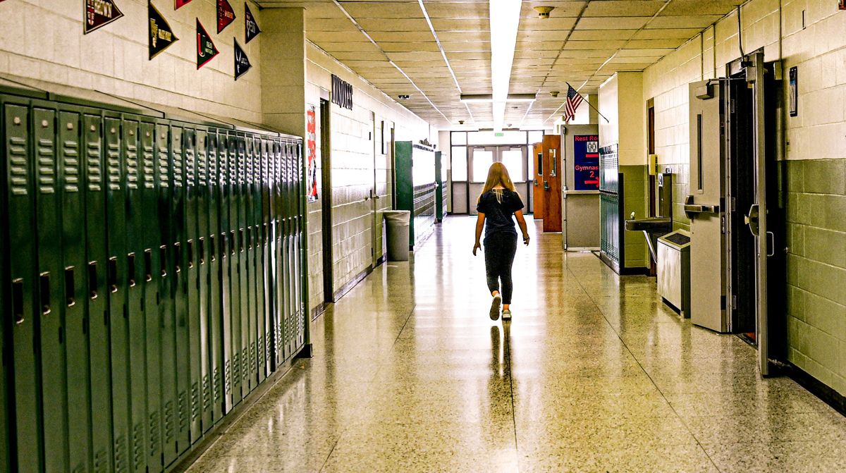 A student walks down a hall at East Valley Middle School on Thursday in Spokane Valley. The district is running a bond in February ballots to replace the the school along with East Valley High School.  (Kathy Plonka/The Spokesman-Review)