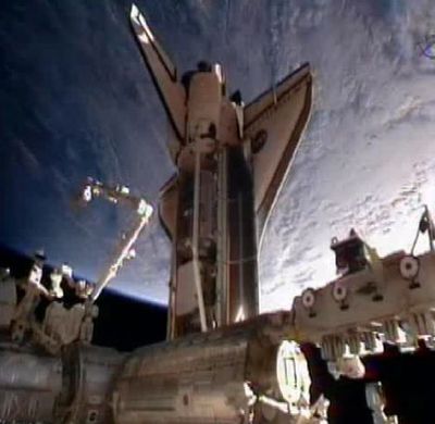 Space shuttle Discovery docks at the International Space Station on Saturday. Discovery is the oldest shuttle and has logged 143 million miles over 26 years. (Associated Press)