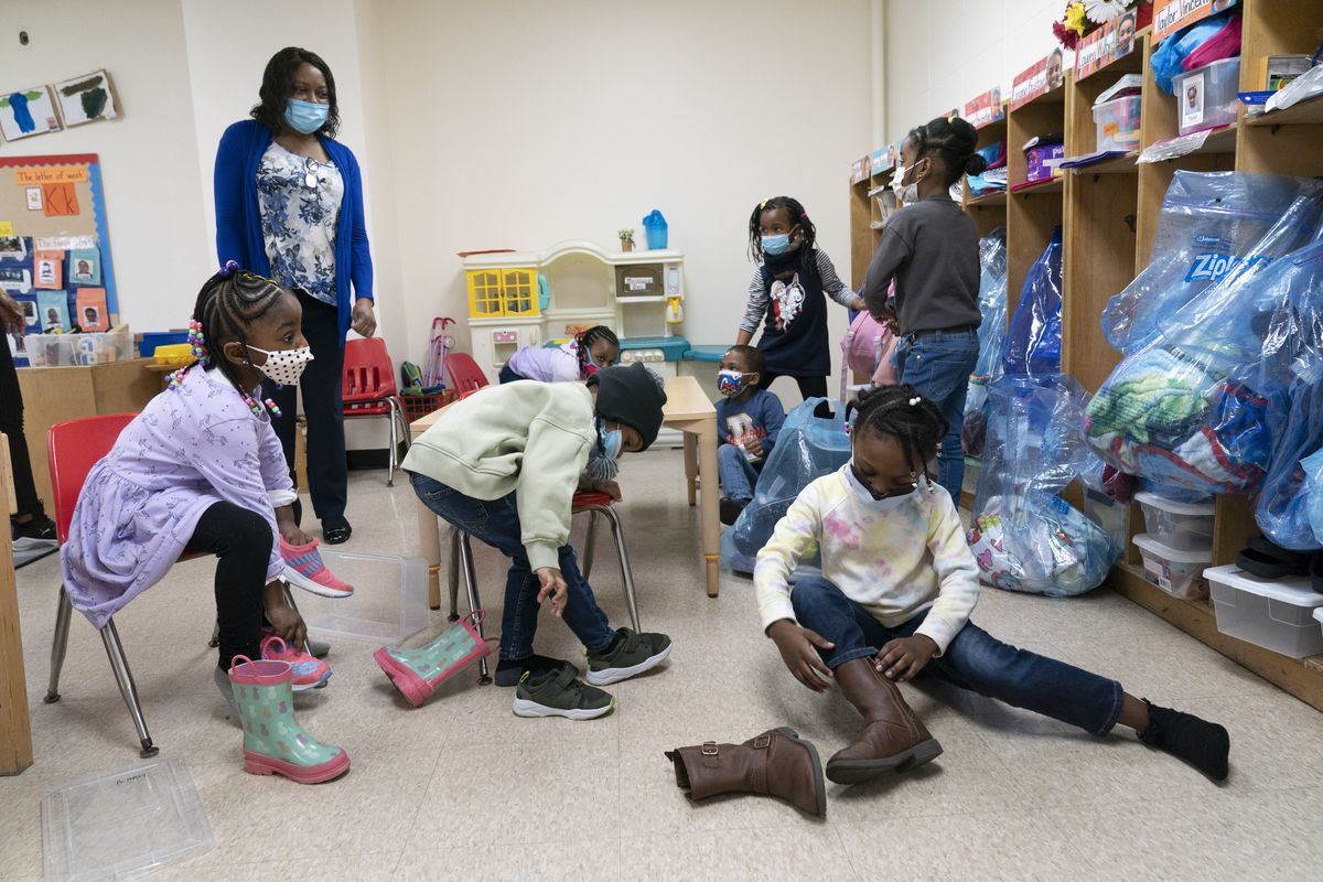 FILE - In this Wednesday, March 24, 2021, file photo, Pre-K students arrive for the school day at Phyl's Academy, in the Brooklyn borough of New York. New York City will require all of its municipal workers — including teachers and police officers — to get coronavirus vaccines by mid-September or face weekly COVID-19 testing, Mayor Bill de Blasio announced Monday, July 26, 2021.  (Mark Lennihan)