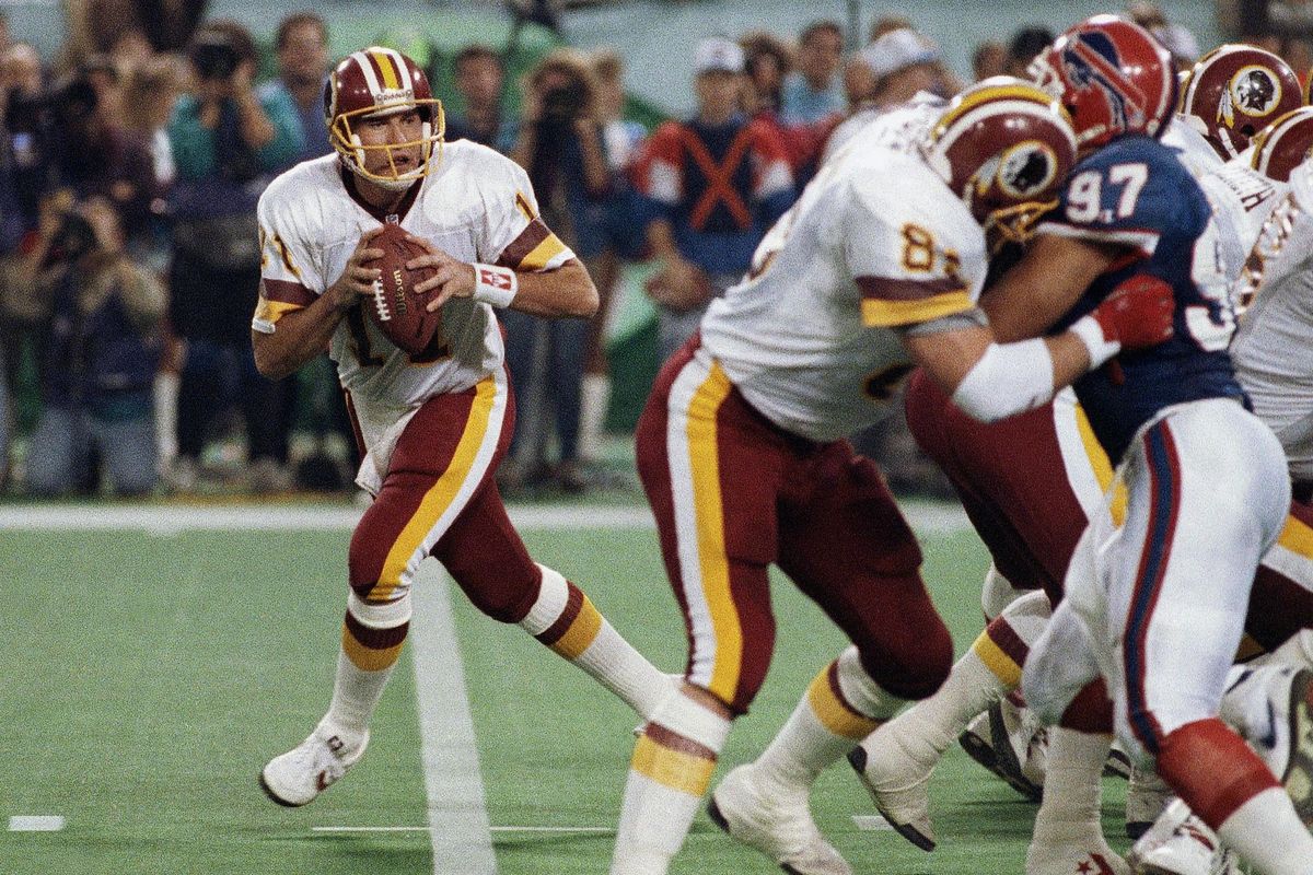 The Washington Redskins’ Don Warren (85) keeps Buffalo Bills Cornelius Bennet (97) away from Redskins quarterback Mark Rypien during Super Bowl XXVI in Minneapolis in 1992. Rypien passed for 292 yards and two touchdowns to lead the Redskins to their third Super Bowl title. (Jim Mone / Associated Press)