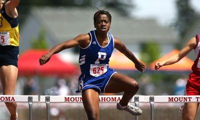 Pullman’s Niina Al-Hassan clears the final hurdle on the way to winning the 300-meter hurdles. Special to  (Patrick Hagerty Special to / The Spokesman-Review)