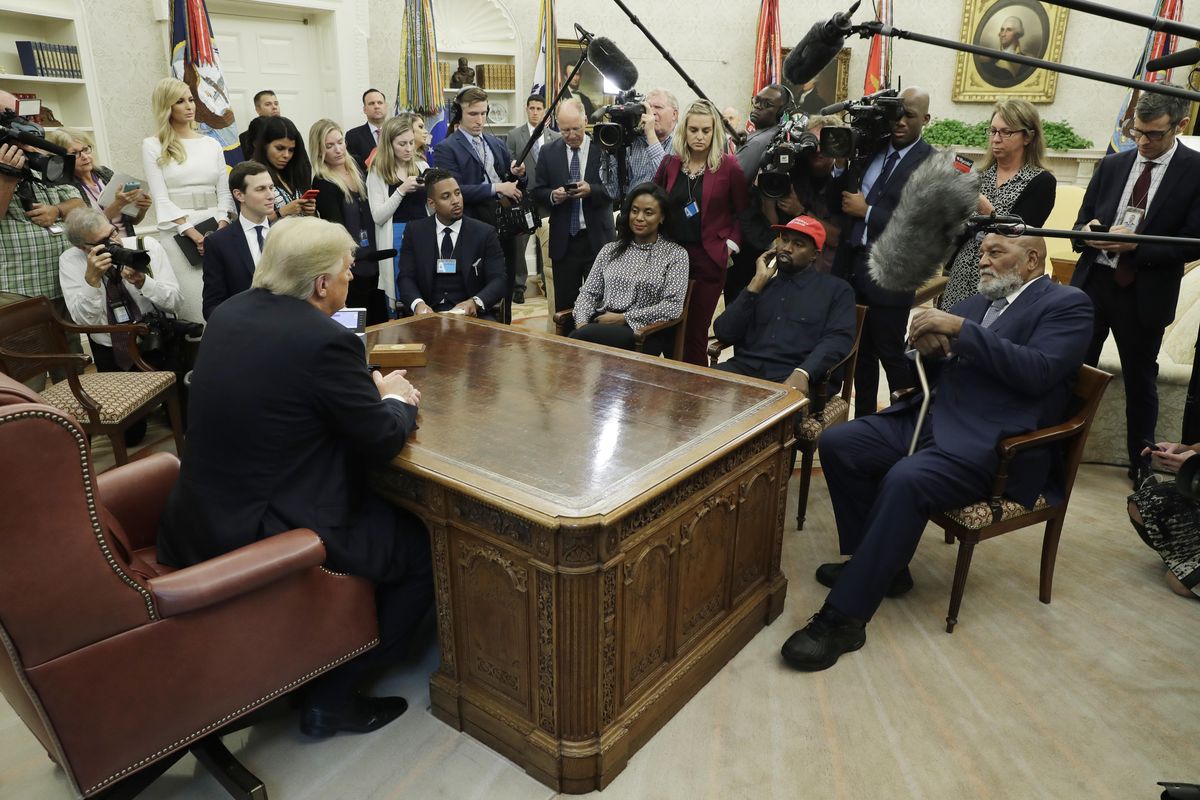 President Donald Trump talks to NFL Hall of Fame football player Jim Brown, seated right, and rapper Kanye West, seated center, and others in the Oval Office of the White House, Thursday, Oct. 11, 2018, in Washington. (Evan Vucci / Associated Press)