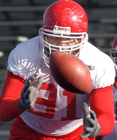
Fresno State's Kenny Avon (91) picks up a loose ball as the Bulldogs practice before today's MPC Computers Bowl.
 (Associated Press / The Spokesman-Review)