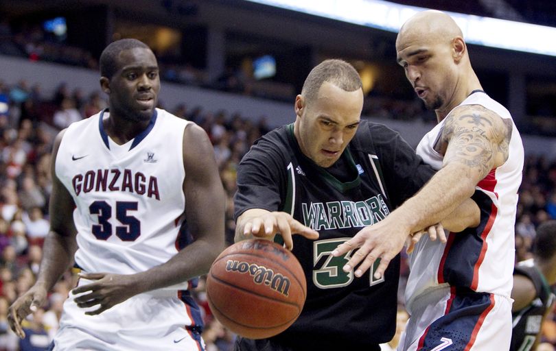 Hawai'i Rainbow Warriors Trevor Wiseman, centre, tries to get past Gonzaga Bulldogs, Sam Dower, left, and Robert Sacre during second half of the 2011 BC Basketball Classic NCAA basketball action at Rogers Arena in Vancouver, British Columbia, Saturday, Nov. 19, 2011. (Jonathan Hayward / Cp)