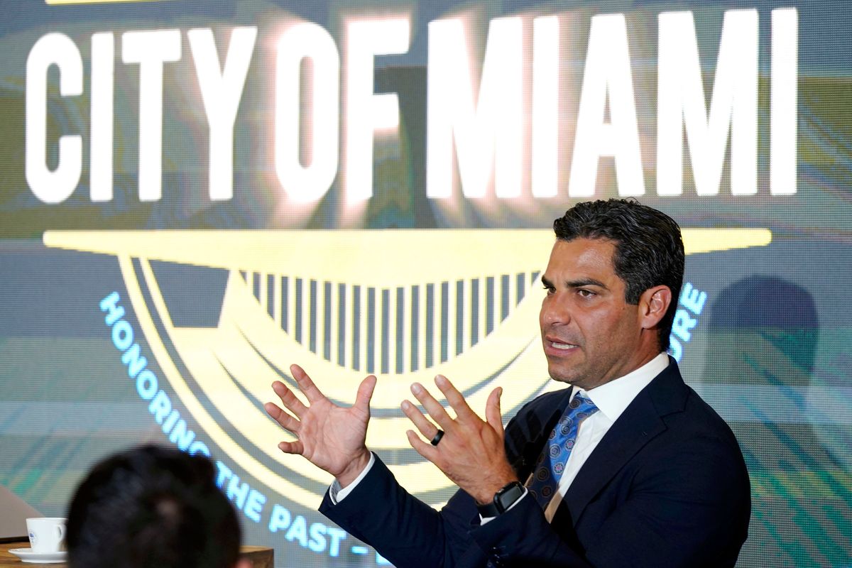 FILE — Miami Mayor Francis Suarez hosts a talk with local artists at the Bakehouse Art Complex, on the emergence of non-fungible tokens (NFTs) in the art world, July 27, 2021, in Miami, Fla. A small but well-publicized group of cryptocurrency enthusiasts called City Coins, is asking Miami and New York to accept the equivalent of millions of dollars in a new cryptocurrency scheme that has political leaders in other cities clamoring to get in on the deal. (Lynne Sladky)