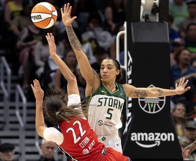 Washington Mystics’ Sonia Citron shoots against Seattle Storm’s Gabby Williams on July 13 at Climate Pledge Arena in Seattle.  (Nick Wagner/Seattle Times)