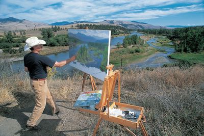 This photo provided by Charles Fritz shows the Billings artist  painting a landscape near Lolo, Mont., where Lewis and Clark and members of the Corps of Discovery camped during their expedition. An exhibit of 100 of Fritz’s paintings illustrating the journey is on display through August at the Buffalo Bill Historical Center in Cody, Wyo.  (Associated Press / The Spokesman-Review)