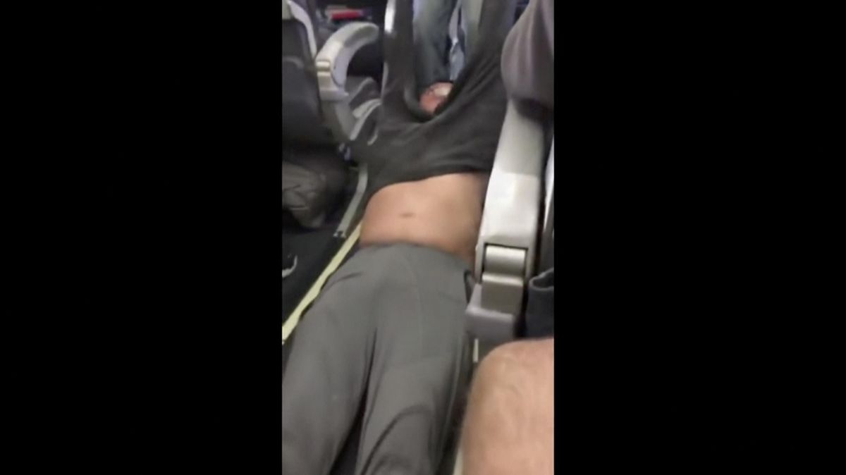 This Sunday, April 9, 2017, image made from a video provided by Audra D. Bridges shows a passenger being removed from a United Airlines flight in Chicago. Video of police officers dragging the passenger from an overbooked United Airlines flight sparked an uproar Monday on social media, and a spokesman for the airline insisted that employees had no choice but to contact authorities to remove the man. (Associated Press)