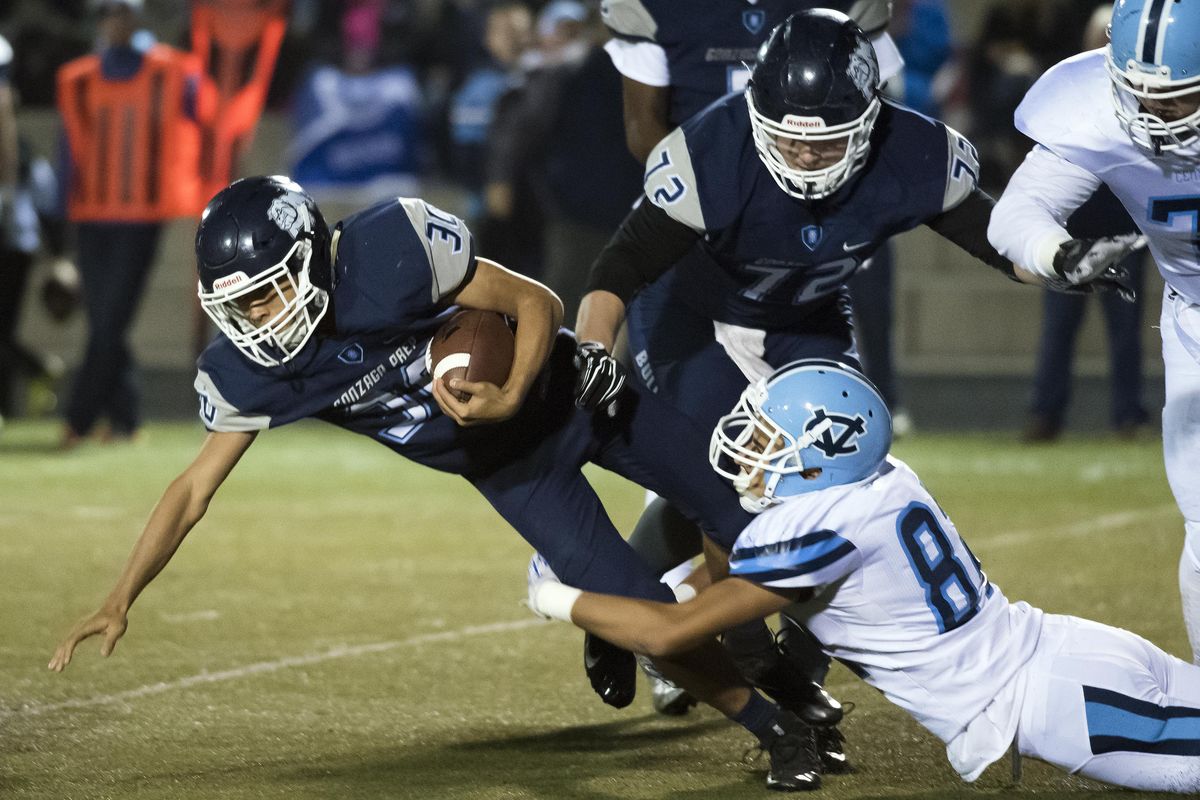 Gonzaga Prep Connor Halonen (30) picks up 5-yards on a run in the first half of a GSL high school football game, Fri., Oct. 28, 2016, at the Gonzaga Prep. (Colin Mulvany / The Spokesman-Review)