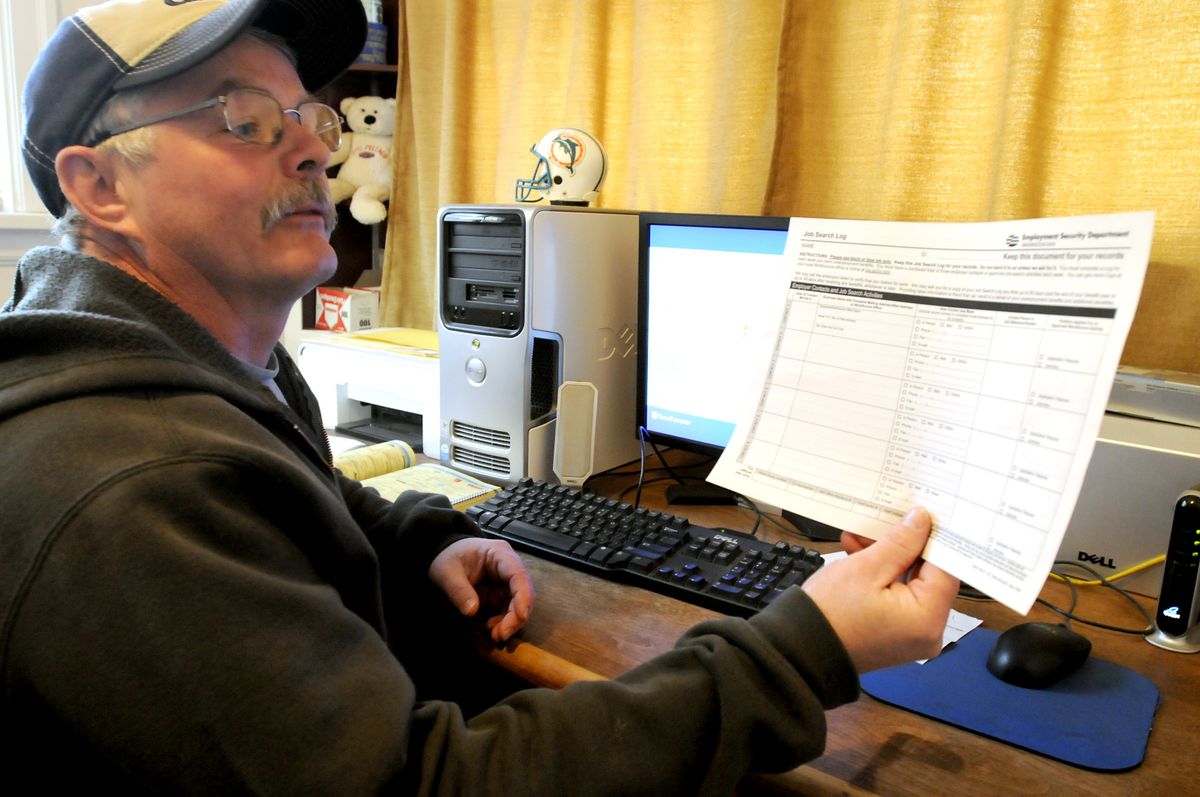 Tom Seim, of Spokane, shows the state form he fills out each time he applies for a job. Seim lost his job recently and is getting by on unemployment until he can find work. He’s required to make three contacts a week to maintain his unemployment.  (Jesse Tinsley / The Spokesman-Review)