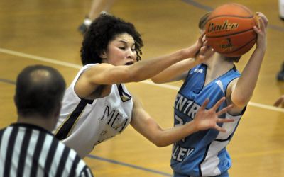 Jazmine Redmon of Mead tries for a steal at midcourt but winds up fouling Jenna Martin of Central Valley. (Christopher Anderson / The Spokesman-Review)